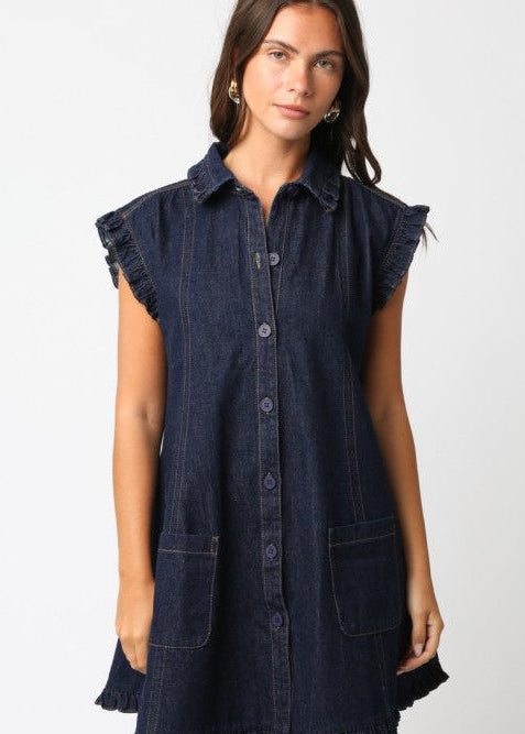 Woman wearing a dark denim dress with ruffled sleeves on a white background