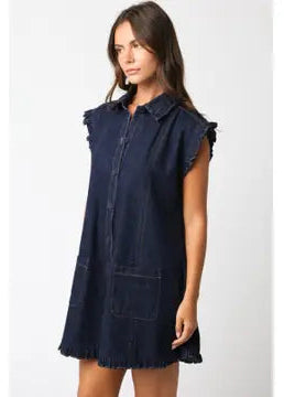 Woman wearing a navy blue sleeveless dress on a white background