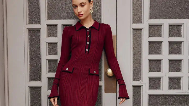 Woman in a burgundy dress standing against a decorative door.